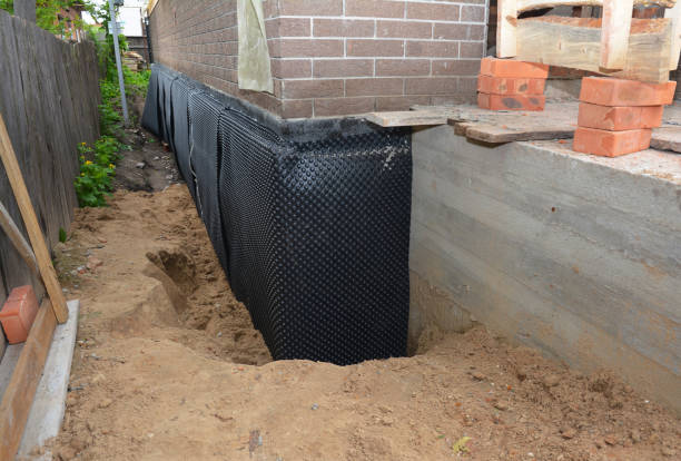 SJ Waterproofing Pros technician performing targeted Interior Drainage System assessment in Victoria, KS